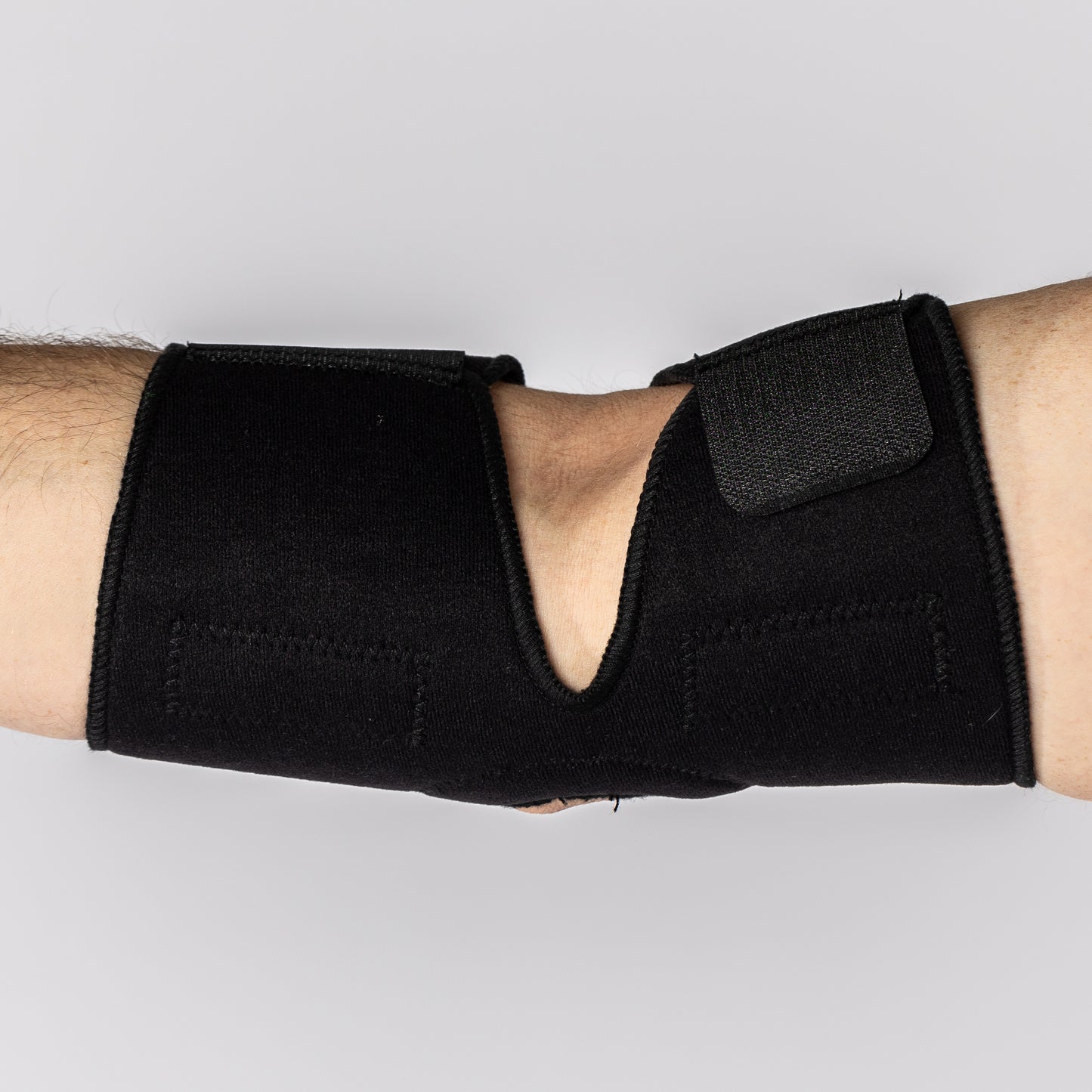 Inside of the elbow view of the Bio Magnetic Elbow Support Brace on a man's arm in black.