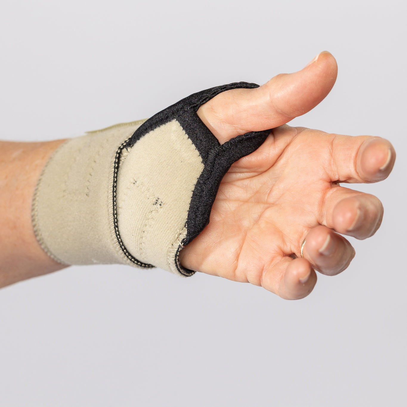 Inside view of the palm on the beige Bio magnetic Wrist Support being worn.