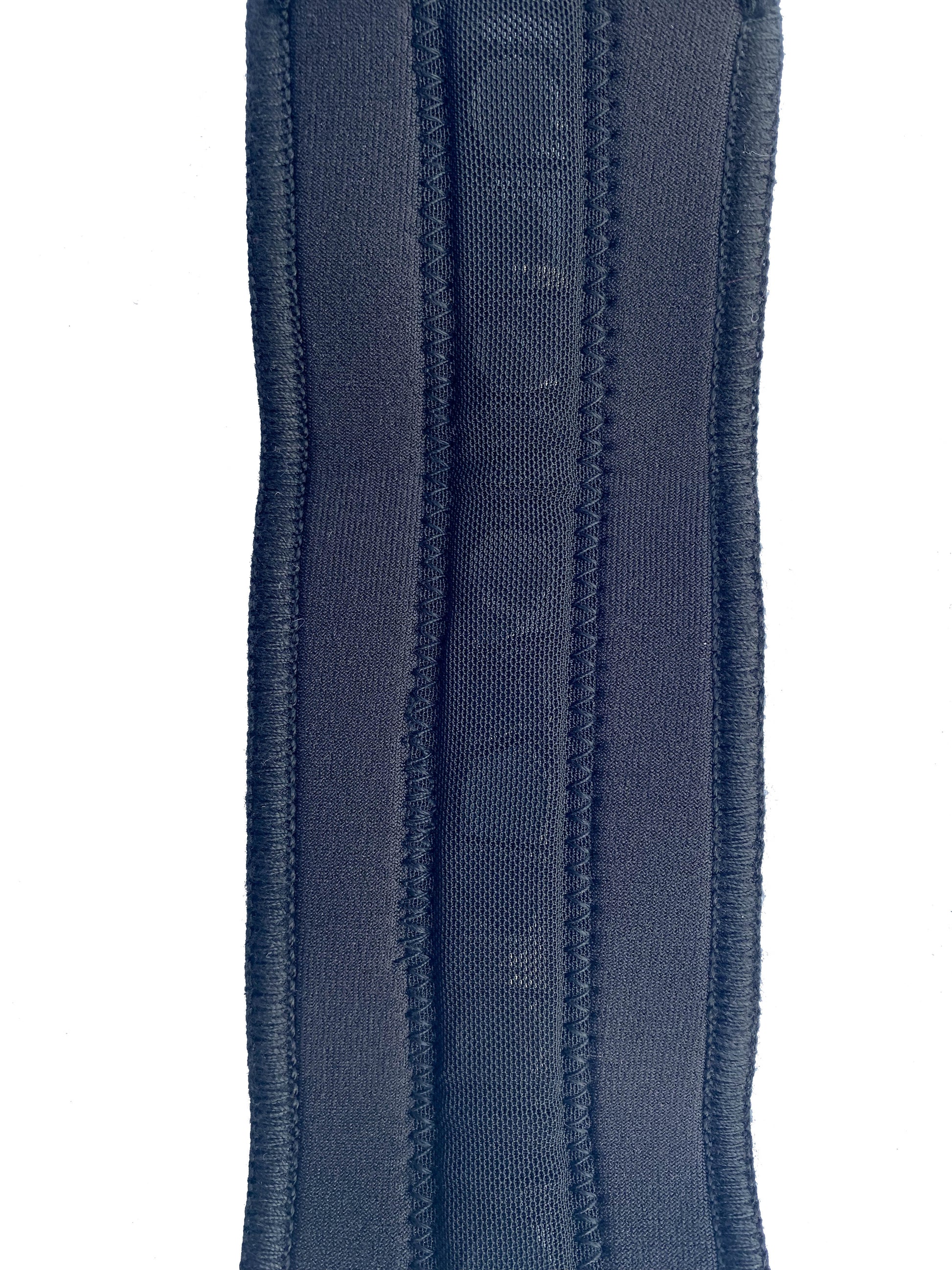 An up close shot of the BioMagnetic Wrist support in black showing the strip of therapeutic magnets.