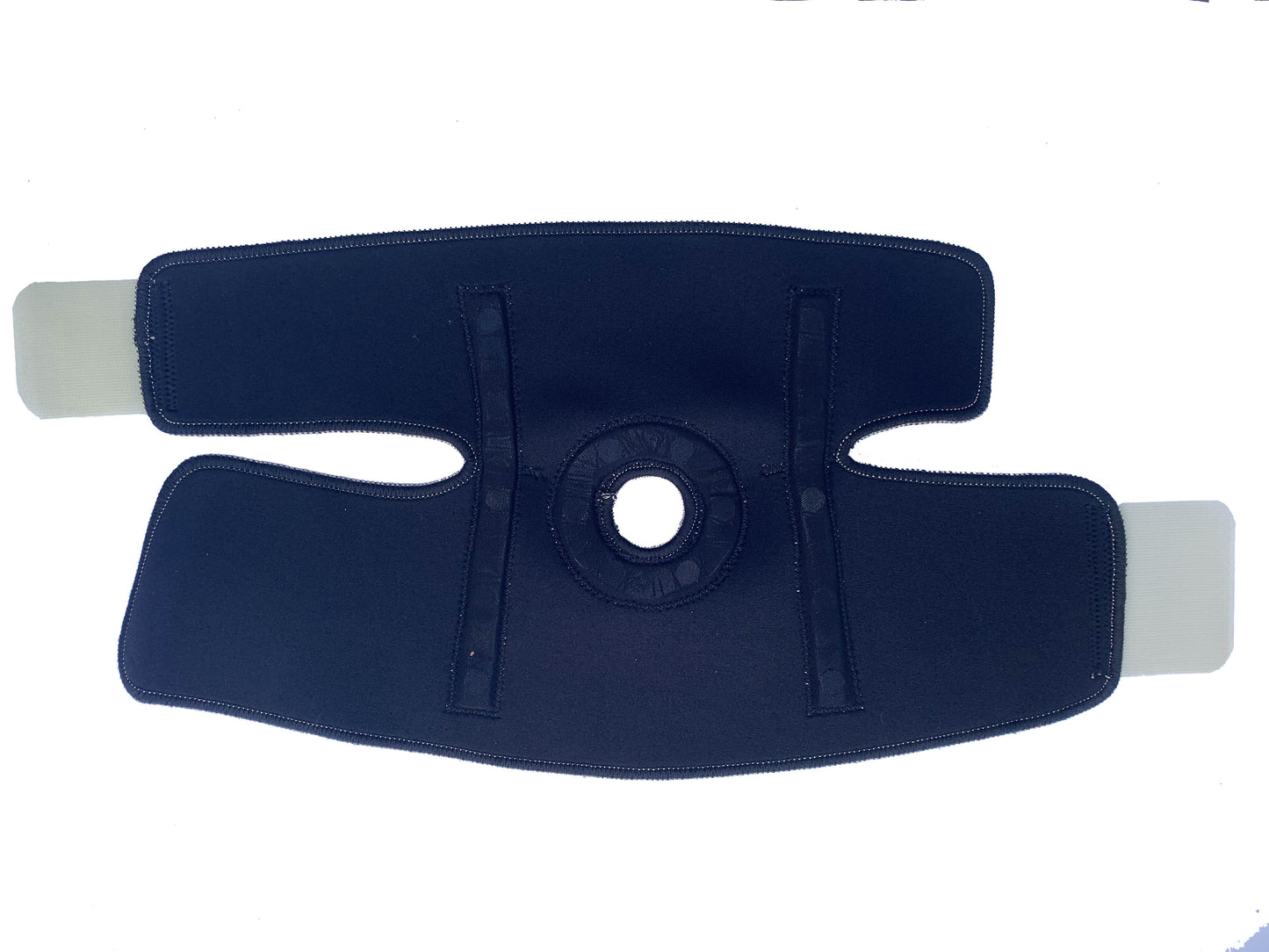 The Bio Magnetic Knee Support in Beige laying flat with the inside face up showing that the lining is black. You can see the two strips of magnets and the circle of magnets embedded into the fabric.