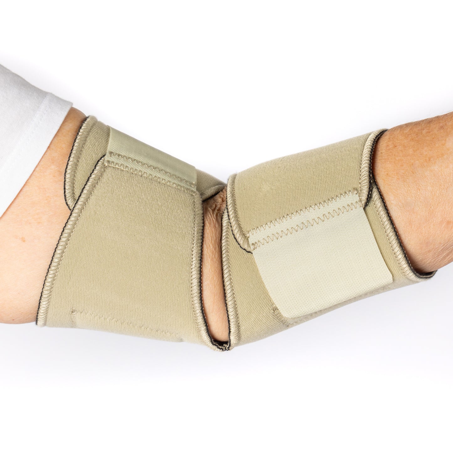 Inside view of the Bio Magnetic Beige Elbow Support Wrap on an elderly woman. 