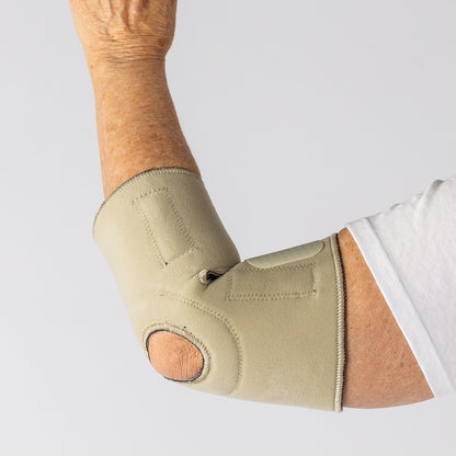 Bio Magnetic Beige Elbow Support Brace from the back view on a woman with her elbow bent and held up.