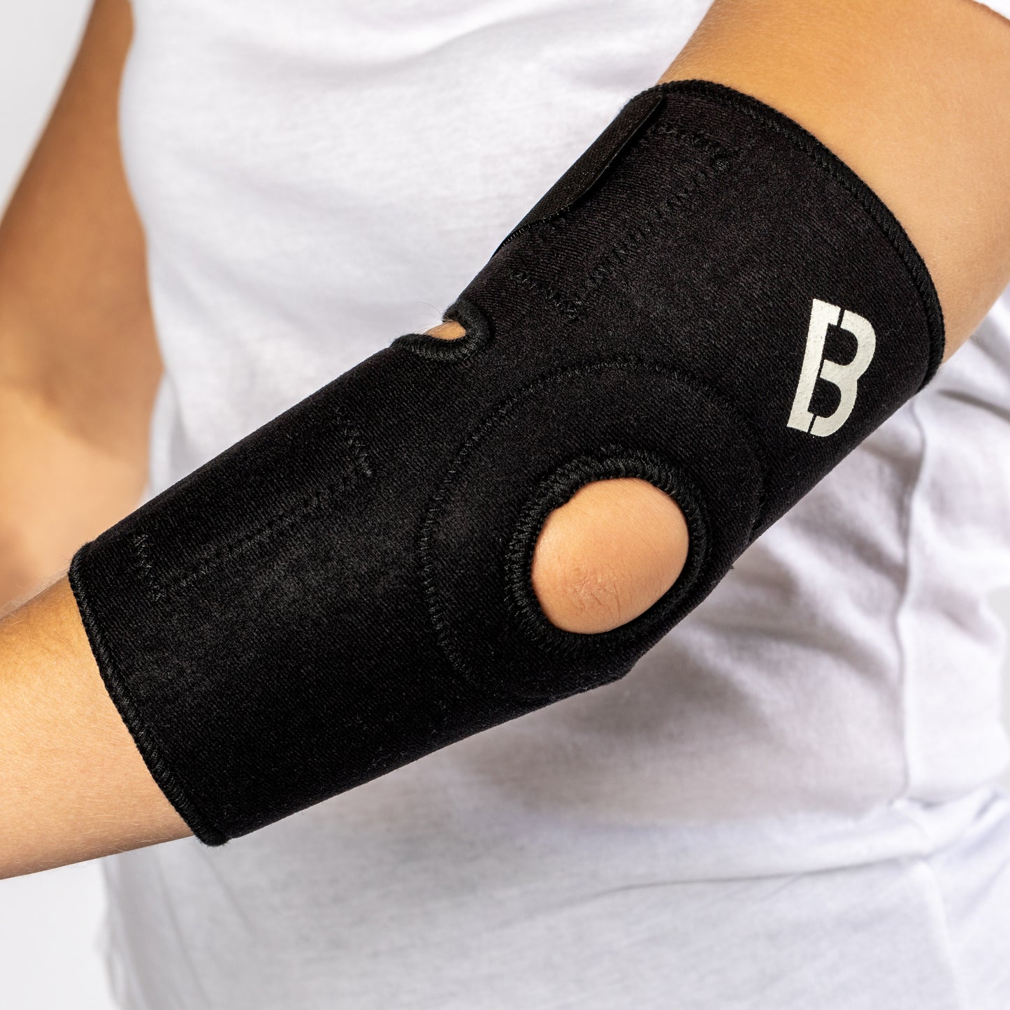 Black Bio Magnetic Elbow Support side view of the flexibility hole. 