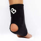 The Bio Magnetic Ankle Support in Black being worn on the right foot with the view from the back, showing the heel hole for added comfort. The 8 therapeutic magnets can be seen sewn into the sides of the support around the ankle. 