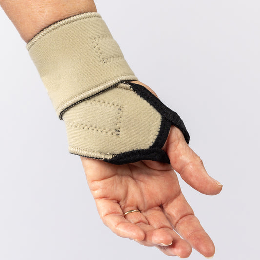 Woman's hand wearing the Bio Magnetic  Wrist Support in Beige, from the inside view of the palm.