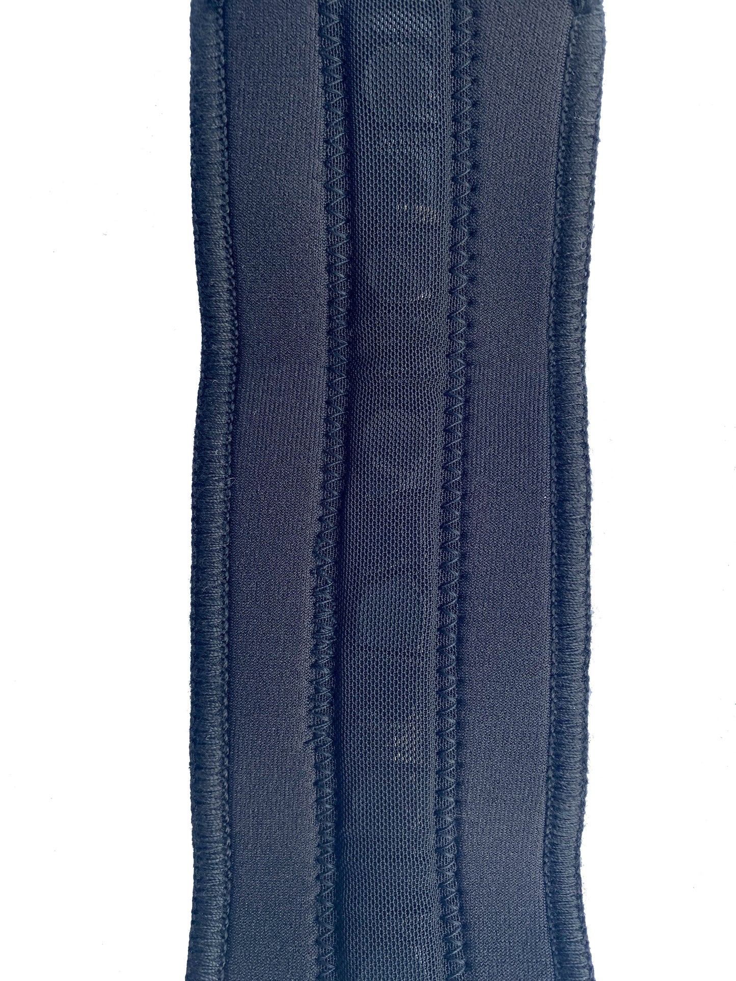 An up close shot of the BioMagnetic Wrist support in black showing the strip of therapeutic magnets. 