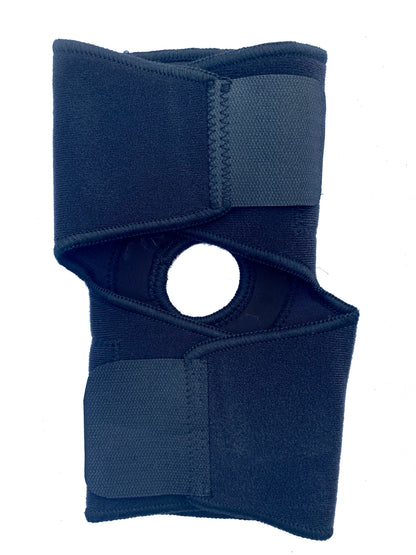 The Bio Magnetic Elbow Support in black laying closed and flat from the back. You can see the adhesive closures are fastened.