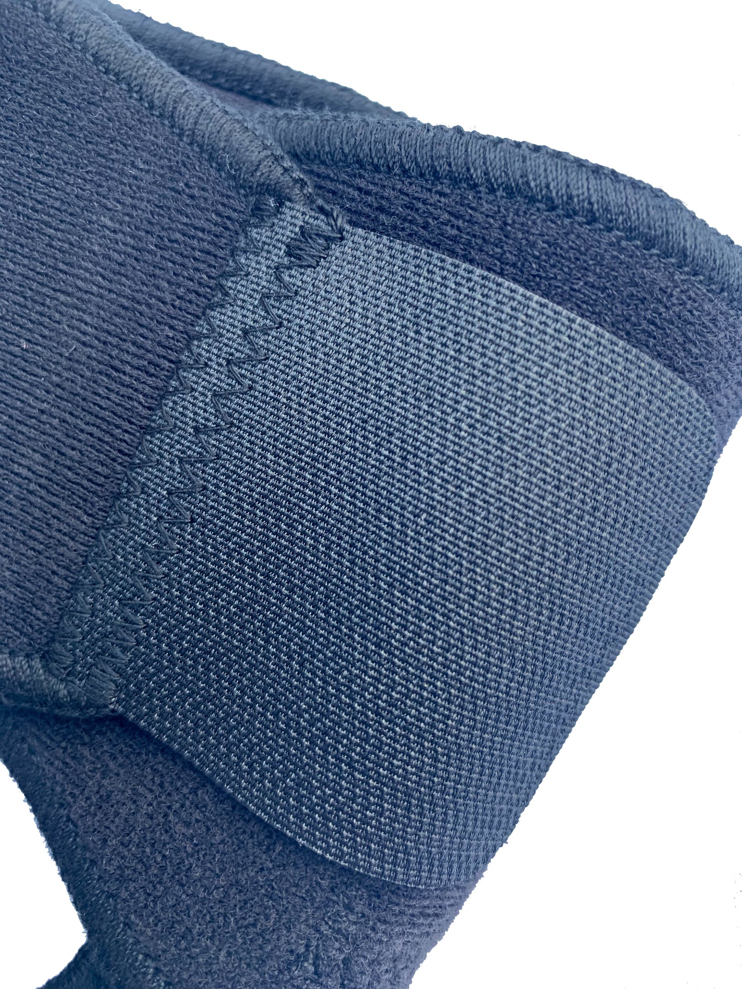 The Bio Magnetic Elbow Support in black up close, showing the quality of the stitching and the quality of the adhesive closure. 