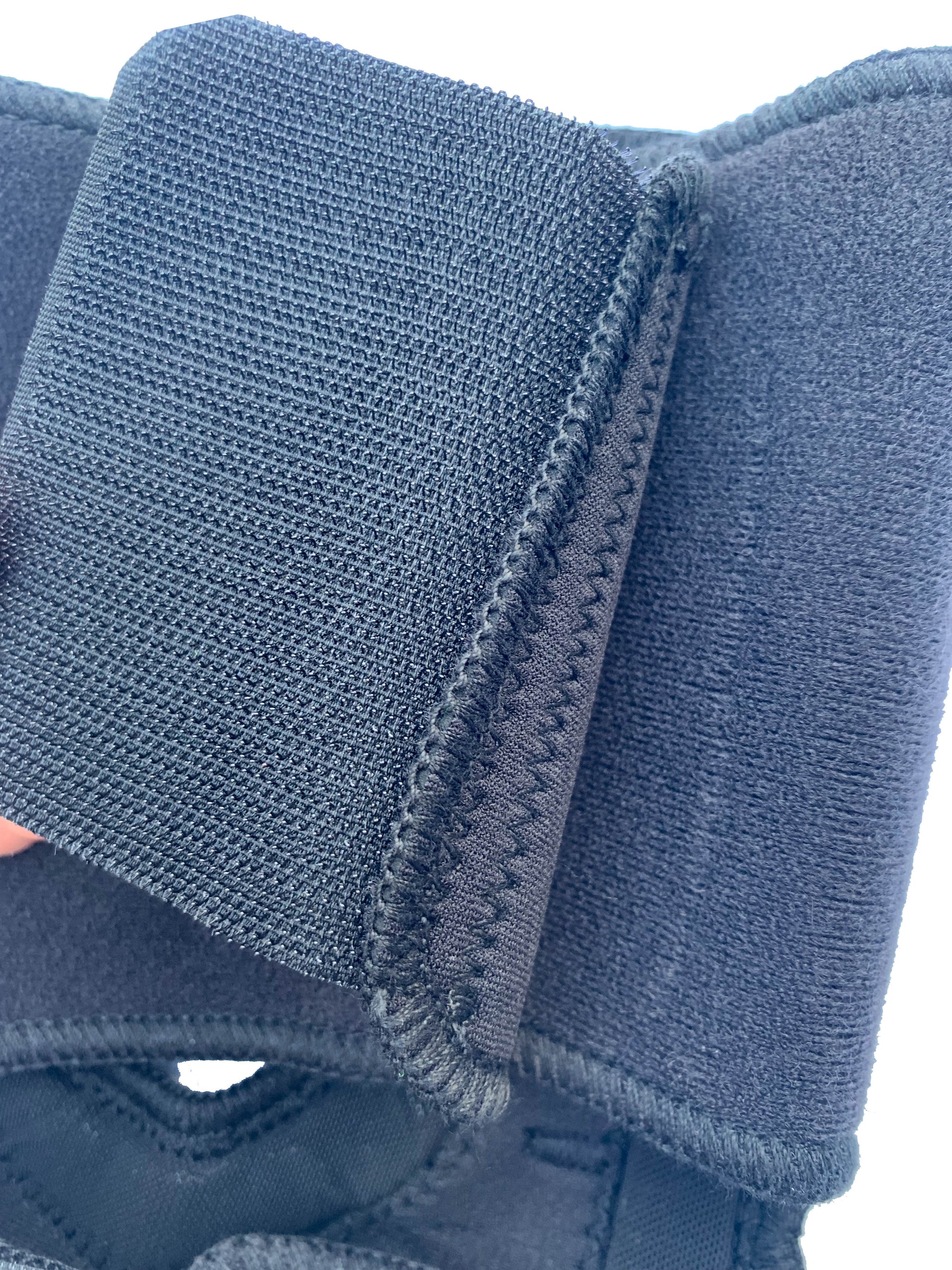 The Bio Magnetic Elbow Support adhesive closure up close. Showing the inside of the hook eye closure and the quality of the stitching. 