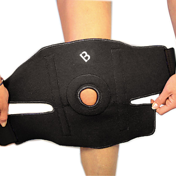 Step one of the Bio magnetic Knee Support being put on. This shows the knee support fully open and being placed on a persons knee cap.